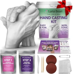 Luna Bean premium DIY hand casting kit displaying a highly detailed plaster sculpture of a couple holding hands, used as a romantic milestone gift.